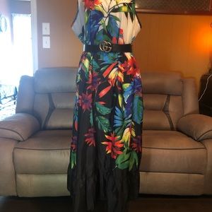 Pretty lined sundress lots colored flowers in pattern, bottom of dress is black.